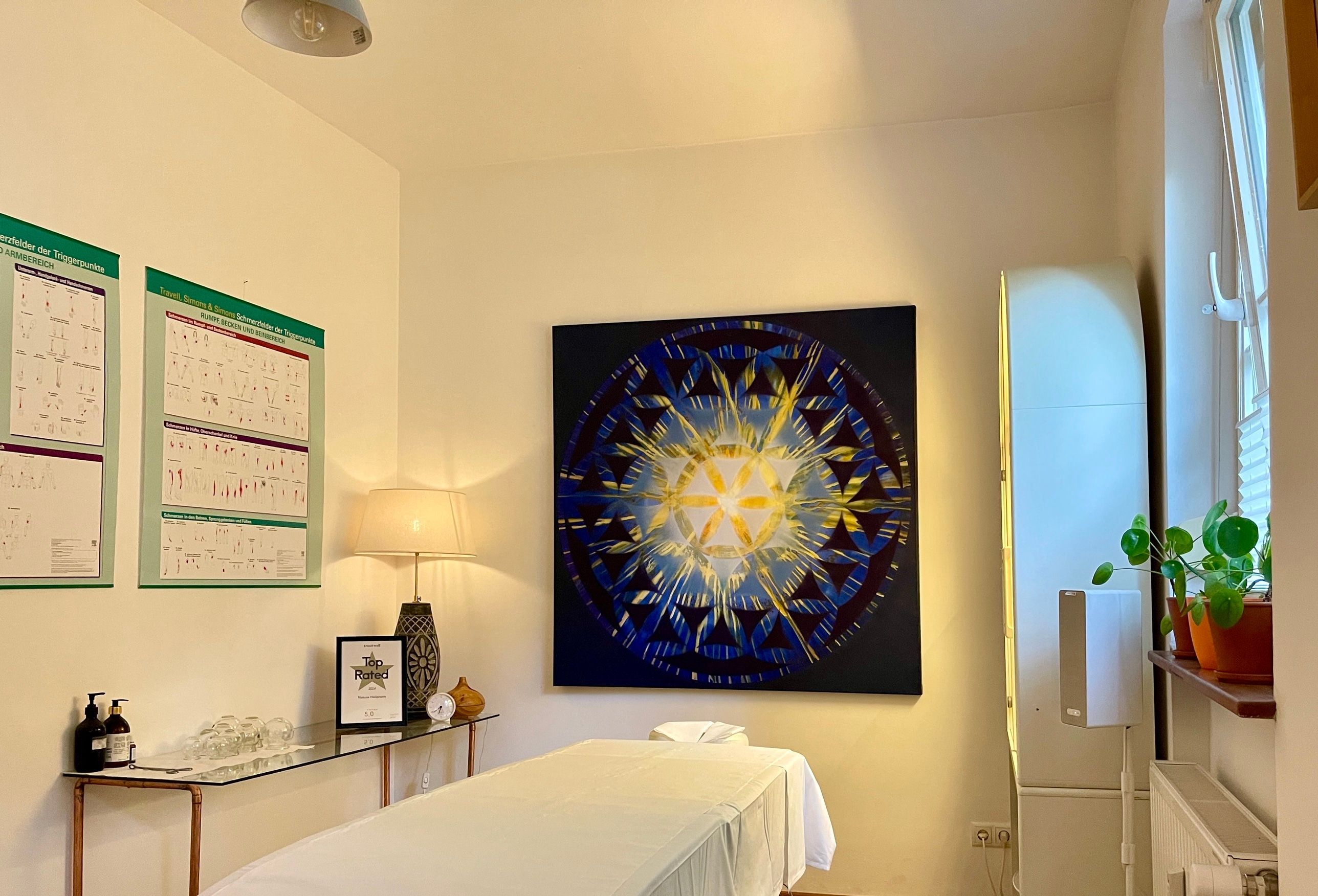 A calm treatment room with a massage table and warm light